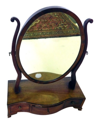 A George III mahogany dressing table mirror, with oval plate, on shaped supports, the serpentine fronted base with three drawers, on ogee bracket feet, 57cm high, 43cm wide.