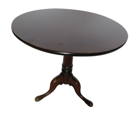 A George III mahogany tilt top table, the tilt top supper table with a circular top, on a turned column with bird cage tripod base, with later added brackets, on pad feet, 72cm high, 74cm diameter.