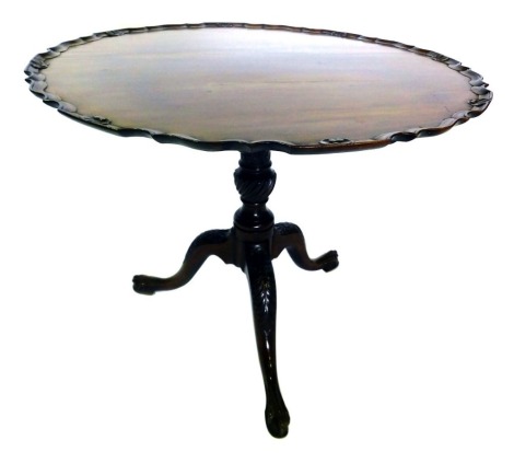 A mahogany tilt top supper table, the piecrust top carved with shells, etc., on a carved turned column and tripod base, with ball and claw feet, 70cm high, 91cm diameter.