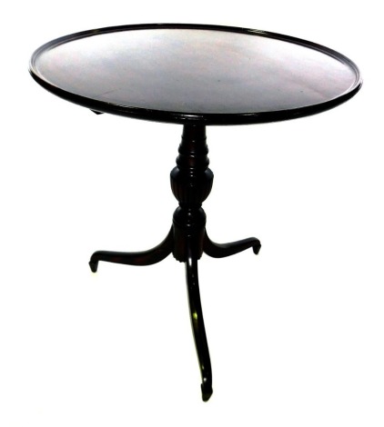 A 19thC mahogany tripod table, the circular dished top on a turned fluted column, on tripod base with tapering feet, 72cm high, 68cm diameter.