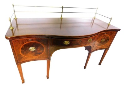 A George III mahogany and boxwood strung sideboard, the serpentine fronted top with a brass gallery, the base with a central drawer flanked by a deep cellarette drawer and a door, on lozenge shaped tapering legs, 112cm high, 168cm wide, 78cm deep.