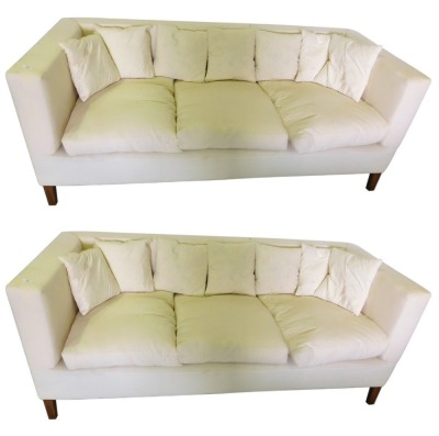 A pair of three seat sofas in George III style, each with square tapering hardwood legs, upholstered in white calico, 112cm wide. The upholstery in this lot does not comply with the 1988 (Fire & Fire Furnishing) Regulations, unless sold to a known export