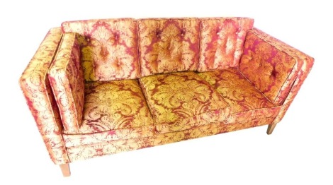 A pair of three seat sofa in George III style, each upholstered in red and gold pattern fabric, on square tapering legs, 186cm wide.