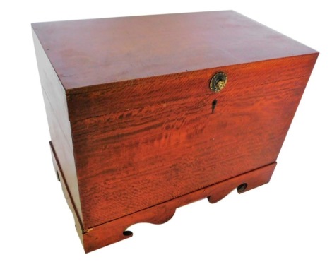 A Colonial figured hardwood chest, the hinged lid with a mask handle, enclosing a vacant interior, with a shaped apron and elongated bracket feet, 56cm high, 75cm wide, 43.5cm deep.