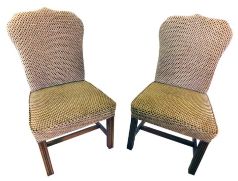 A set of twelve mahogany dining chairs, each with a shield shaped padded back, and a padded seat upholstered in chequered fabric, on plain reeded legs with H stretcher.