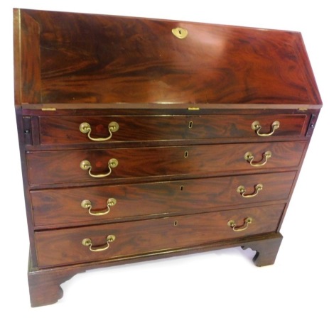 A George III mahogany bureau, the fall enclosing a fitted interior, above four graduated drawers with brass drop handles, on bracket feet, 104cm high, 106cm wide, 49cm deep.