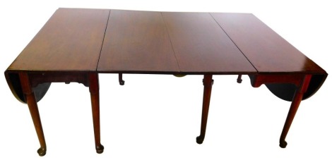 A 19thC mahogany extending dining table, comprising two drop leaf sections with a rounded and rectangular leaf, on turned tapering legs, with pad feet, 71cm high, 115cm wide, 269cm long.