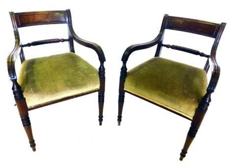 A set of four mahogany and ebony strung chairs in George IV style, each with a bar back, a rope twist rail, channelled arms, and a padded seat, on turned tapering legs.