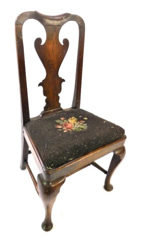 A George II walnut side chair, with solid splat, drop in wool work seat, on cabriole legs with pad feet and H stretcher.