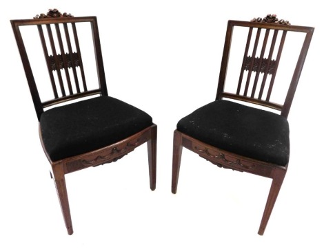 A set of ten late 19th/early 20thC mahogany dining chairs, each with a ribbon carved crest, a bar back, and a drop in seat, on square tapering legs.