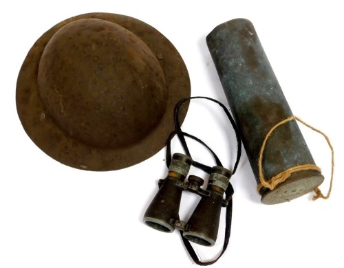 A World War I British Brodie helmet shell, World War I German binoculars, and a shell case.