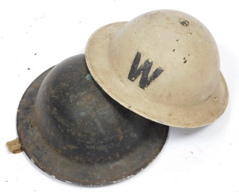 Two World War II tin helmets, to include Wardens example.