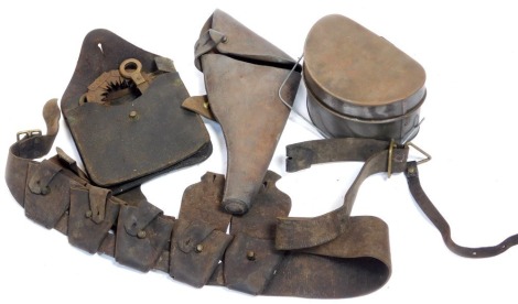 A World War I period holster, saw, bandolier, and a mess tin.