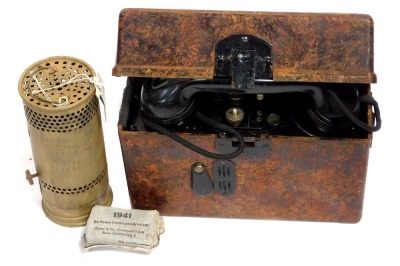 A World War II German field telephone, first aid pack, and associated vehicle heater.