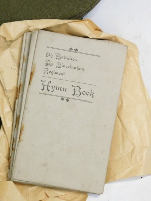 Various military hats, with Royal Lincolnshire and Lincolnshire Regiment badges on, together with hymn books. - 2