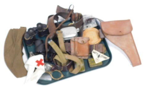 A selection of militaria, to include binoculars, holster, cap, tins, etc.