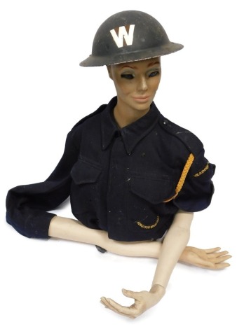 A post World War II Civil Defence battle dress, and associated Warden helmet on a women's torso.