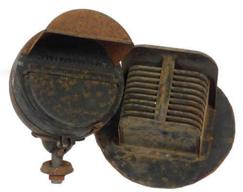 Two World War II black out car headlamp covers.