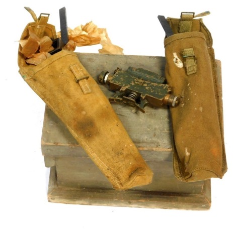 A World War I wooden box, World War II 1944 dated clinometer, and associated equipment.