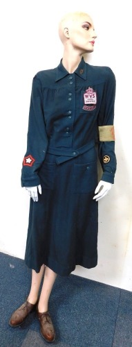 A female mannequin wearing WVS Women's Voluntary Service style dress.