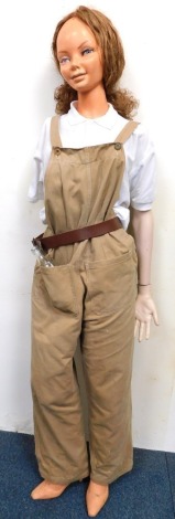 A female mannequin wearing Women's Land Army bib and brace.