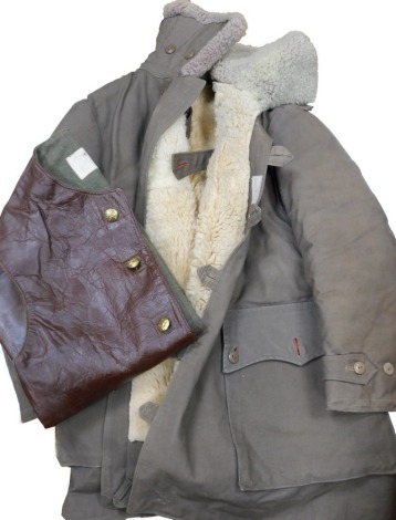 A military cold weather jacket and leather jerkin.