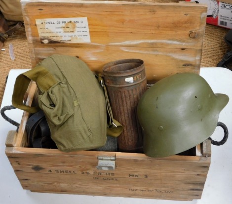 An ammo box containing various items of militaria, tin helmet, gas mask, water bottles, etc.