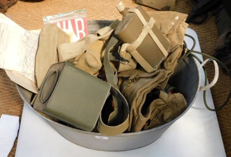 A tin tub containing various items of militaria, to include water bottle, webbing pouches, maps, gun webbing kit, etc.