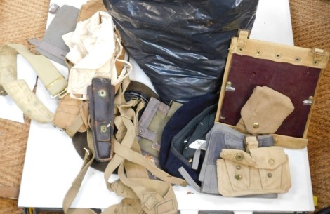 A bag containing various pieces of webbing, gaiters, belts, etc., mainly post war.