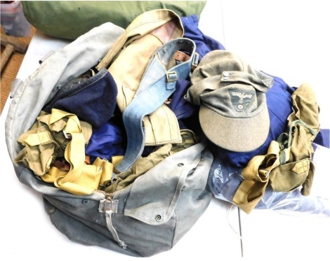 A bag containing various military reenactment items, to include hats, belts, bags, blue coveralls, etc.