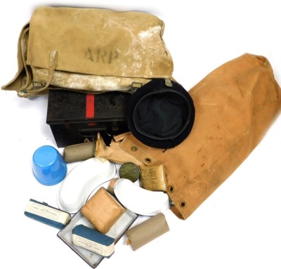 A World War II ARP medical satchel, first aid tin, and associated equipment.