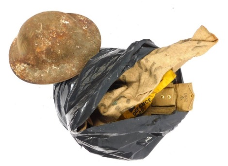 A bag of military items, to include tin helmet shell, webbing, straps, arm bands, etc. (AF)