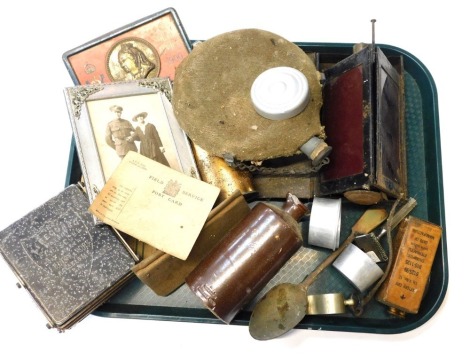 A selection of military items, to include South Africa 1900 Boer War tin, water bottle, Field Service postcard, periscope, etc.