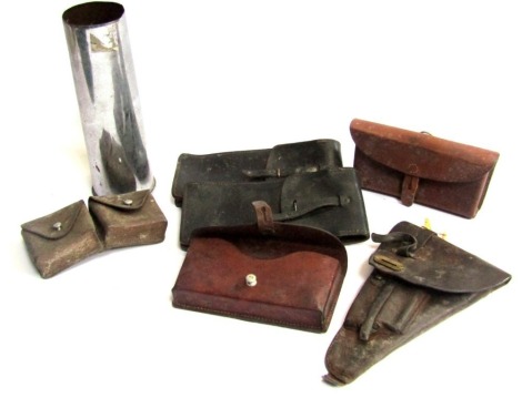 A selection of military leather ammo pouches, holster, World War I shell case, etc.