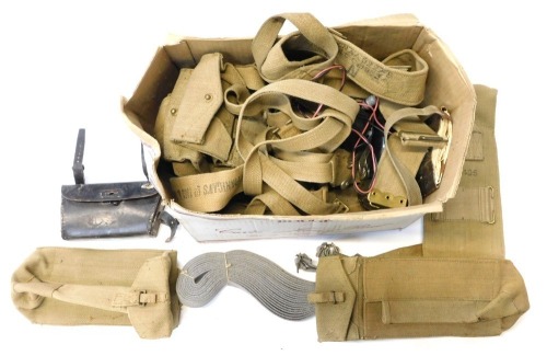 A box containing military webbing, to include pouches, straps, belts, etc., mainly post war.