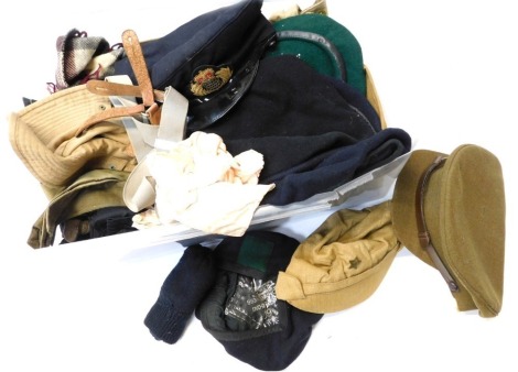 A selection of berets, military and civilian hats, etc.