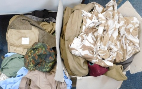 Two boxes of military uniforms, to include Dessert DPM 1949 pattern BD East German camouflage cap, etc.