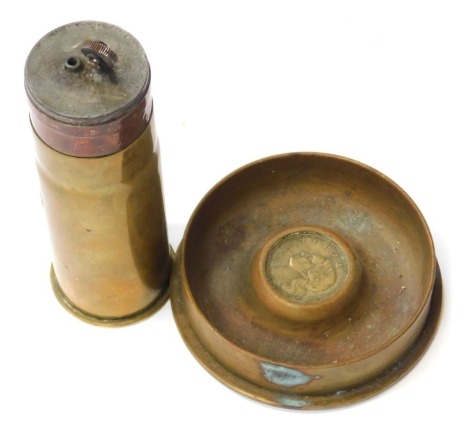 Two pieces of World War I trench art, a lighter made from a pompom round, and a shell bottom ashtray.