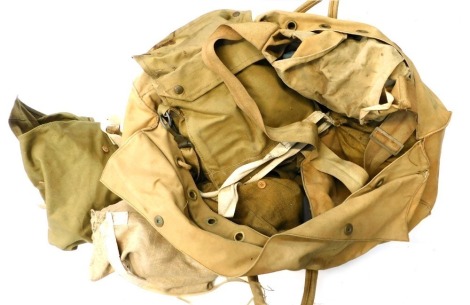 A military holdall, containing gas masks, civilian, webbing, first aid pouch, etc.