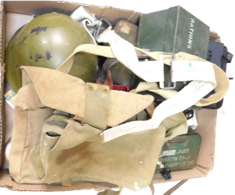 A selection of military items, to include helmet, tins, webbing packs, torch, etc.