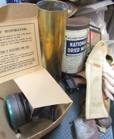 Militaria, to include Welfare Food Service National Dried Milk tin containing military buttons, gas mask, stereoscope type D, shell cases, cap gun, etc. (1 tray)