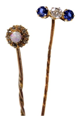 A sapphire and diamond three stone tie pin, set in yellow metal, together with an opal tie pin in a surround of old cut diamonds, in yellow metal, 3.1g. - 2