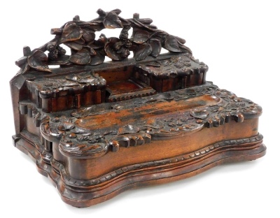 A Victorian carved oak desk stand, the back carved with branches and leaves, above two small drawers, the tops carved with leaves and berries, the remaining top similarly carved with a pen and inkwell recess, over a semi secret side drawer, raised on a se - 3