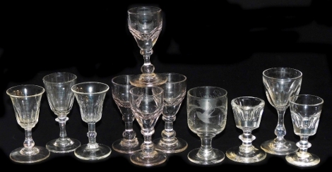 A group of early 19thC and later small wine or liqueur glasses, to include a set of four with pink tint and similar with faceted bowls, plain glass engraved A Present from Bridgenorth, and a penny lick ice cream glass. (11)