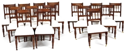 A harlequin set of fifteen late Victorian walnut dining chairs, each with spindle turned backs, a calico upholstered padded seat, on turned legs, six with castors. (6+9)