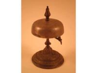 A brass desk bell, the domed base cast with leaves, 15cm high<br