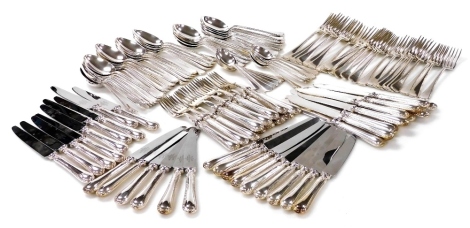 An Elizabeth II Mappin and Webb suite of feather pattern silver flatware, comprising twenty four table forks and dessert spoons, twelve soup spoons, twelve teaspoons, twelve fish knives and forks, and twenty four table knives, 165.51oz excluding table kni