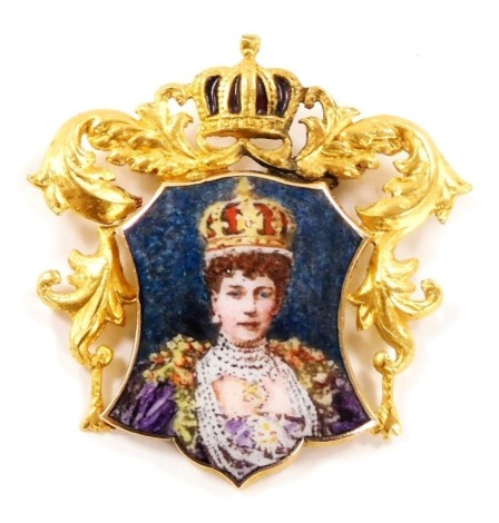 An Edwardian enamel court jewel pendant, of shield form, decorated with a bust portrait of Queen Alexandra, within a yellow metal mount with scrolling leaves and crown surmount, stamped 18ct, 5.3g