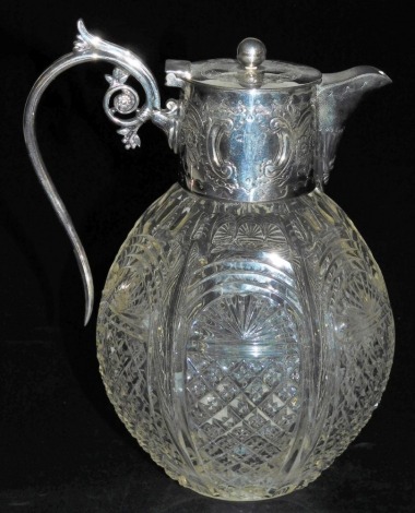 A Victorian cut glass claret jug, with silver mount, spout, and scrolling handle, with a hinged lid, embossed with flowers and rococo scrolls, reserve initial engraved, Pinder Brothers, Sheffield 1894, 20cm high.