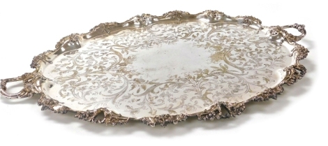 A Victorian silver plated twin handled tray, with central floral and foliate engraving, within a raised border embossed with flowers, tendrils and foliate scrolls, 90cm wide.